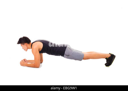 young fitness man doing plank core exercise working out Stock Photo