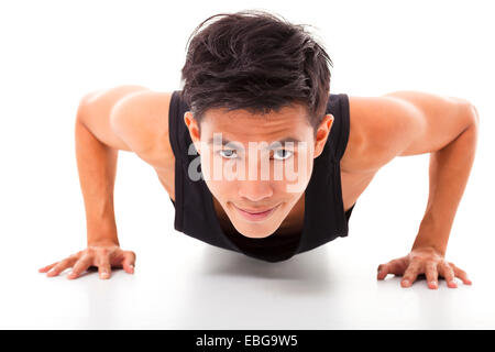 smiling young fitness man exercising push up Stock Photo