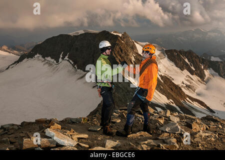 Mountain climbers congratulating one another following the ascent to the summit of Wilder Pfaff Mountain, Stubai Valley Stock Photo