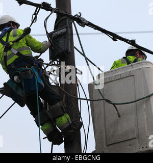 Two power supply workers replacing electric cables. Stock Photo