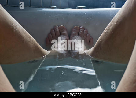 A man's feet in the bathtub. Stock Photo