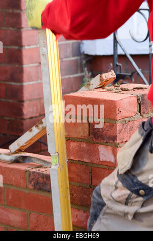 Bricklaying - checking the wall is straight Stock Photo