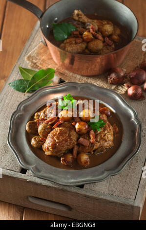 Coq au vin. Chicken cooked with red wine. France Food Stock Photo