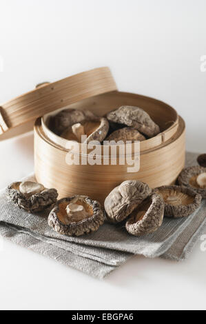 Dried shiitake mushrooms in Chinese steamer basket Stock Photo