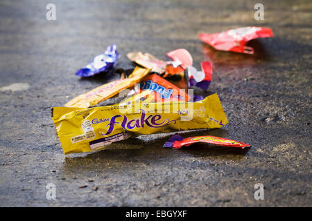 Empty sweet wrappers littering the pathway. Stock Photo