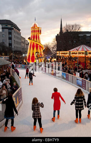 Fair Rides Scotland Ice Rink with fun fair rides in background St Andrew Square, Edinburgh ...