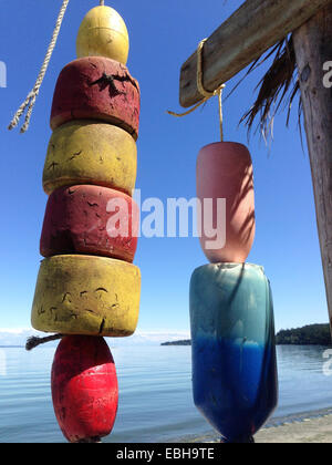 Colourful floats hanging on beach Stock Photo