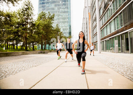 Personal trainers doing outdoor training in urban place, Munich, Bavaria, Germany Stock Photo