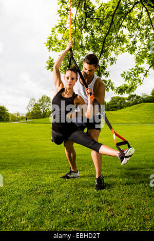 Personal trainers doing outdoor training in urban place, Munich, Bavaria, Germany Stock Photo