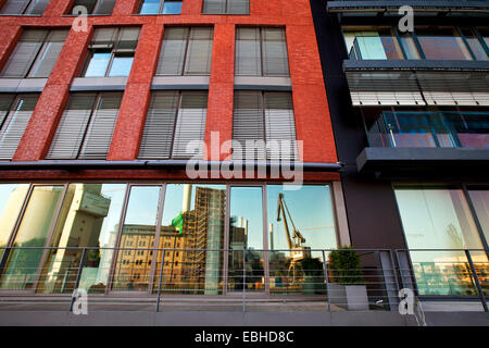 crane mirrors in the glass of the modern buildings at the Kreativkai, Europe, Germany, North Rhine-Westphalia, Muensterland Stock Photo