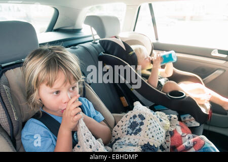 Two boys in car seats Stock Photo
