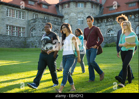 Students walking across grass