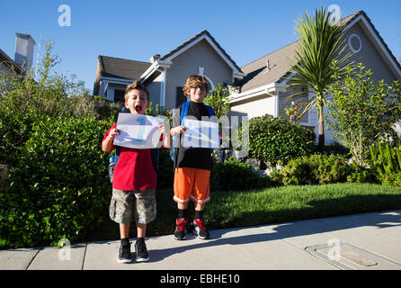 Portrait of two brothers holding up pieces of paper with 1 & 3 Stock Photo