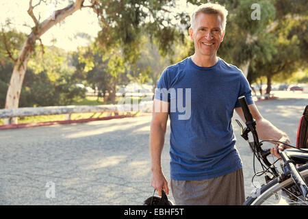 Portrait of mature male cyclist in park