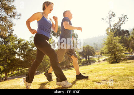 Mature couple power walking in park Stock Photo