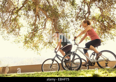 Mature couple cycling in park
