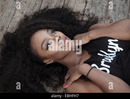 Young woman with black hair lying down Stock Photo