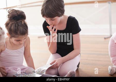 Girls swapping stickers in ballet school Stock Photo