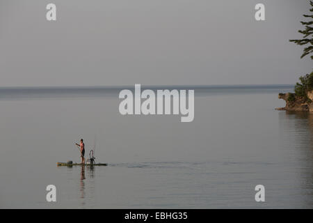 Teenage boy fishing on pier, Lake Superior, Gwinn, Michigan, USA