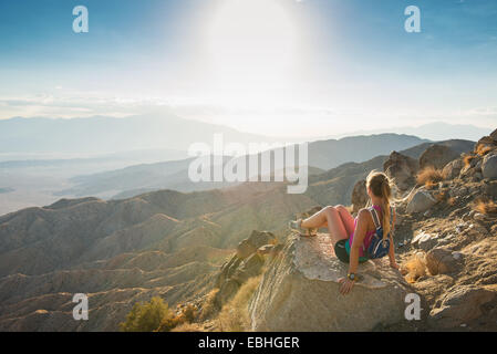 Woman taking break on mountain, Joshua Tree National Park, California, US Stock Photo