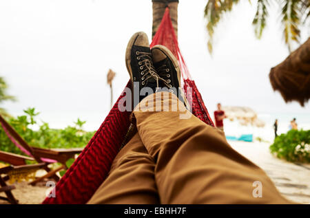 Mature mans self portrait of legs in beach hammock Stock Photo
