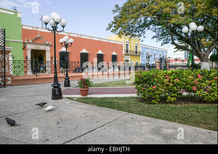 Restored Spanish colonial architecture with ornate wrought iron fence across from a city center park in the historic city of Campeche, Mexico. Stock Photo