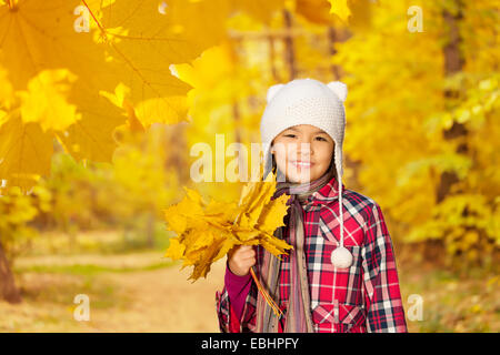 Asian girl close up view with bunch of leaves Stock Photo