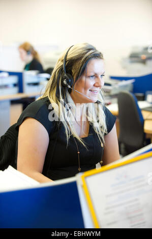 Young woman with headset on in a call centre Stock Photo