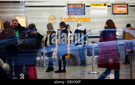 Berlin, Germany. 1st Dec, 2014. Passengers gather near Lufthansa's check-in desks in Tegel airport, Berlin, Germany, on Dec. 1, 2014. German airline Lufthansa said on Monday that it had canceled nearly half of its scheduled flights on Monday and Tuesday due to a strike by its pilots. © Zhang Fan/Xinhua/Alamy Live News Stock Photo