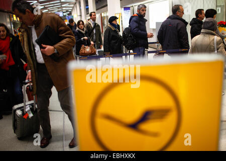 Berlin, Germany. 1st Dec, 2014. Passengers gather near Lufthansa's check-in desks in Tegel airport, Berlin, Germany, on Dec. 1, 2014. German airline Lufthansa said on Monday that it had canceled nearly half of its scheduled flights on Monday and Tuesday due to a strike by its pilots. © Zhang Fan/Xinhua/Alamy Live News Stock Photo