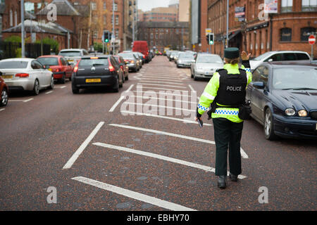 Ormeau Avenue,Belfast,UK Northern Ireland. 1st Dec 2014. A PSNI officer waves traffic through at a police check point. The Police in Northern Ireland have increased on the ground policing due to raised terror threat in the run-up to Christmas Credit:  Bonzo/Alamy Live News Stock Photo