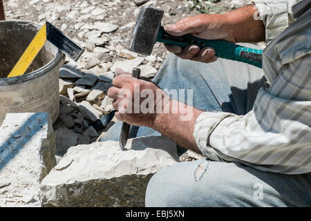 Close-up of a Stonemason at work. Photographed in Greece Stock Photo