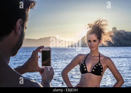 Man photographing young woman on vacation Stock Photo