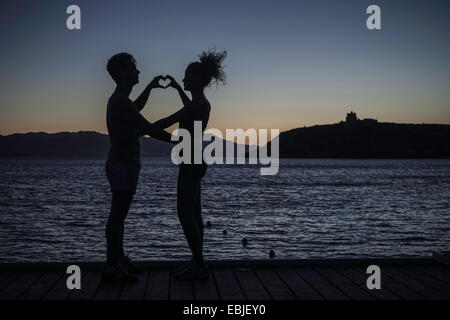 Side view of naked couple making love in nature Stock Photo - Alamy