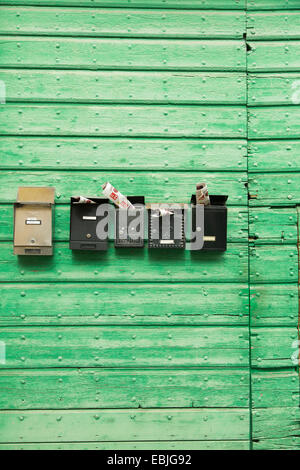 Mail boxes on wooden wall Stock Photo