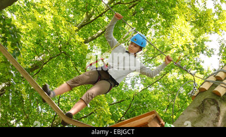 girl balancing on rope of high rope course