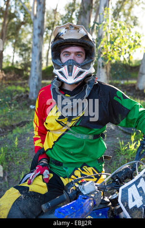Portrait of young male motocross racer in forest Stock Photo