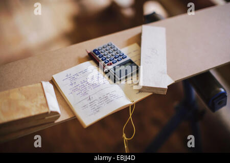 Still life of notebook and calculator in pipe organ workshop Stock Photo