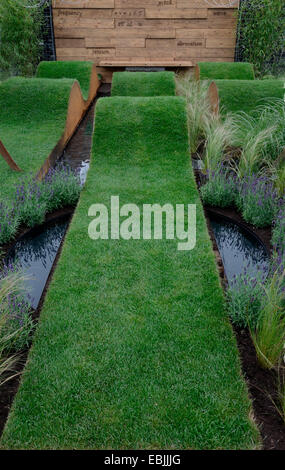 Undulating lawns in a garden replicating sound waves with grasses and lavender Stock Photo