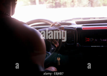 Cropped close up of young man driving on car road trip Stock Photo