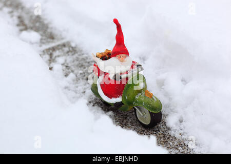 Santa claus on motor bike, ceramic figure in snow, Switzerland Stock Photo