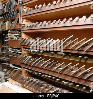 Rows of shelves and tools in traditional bookbinding workshop Stock Photo