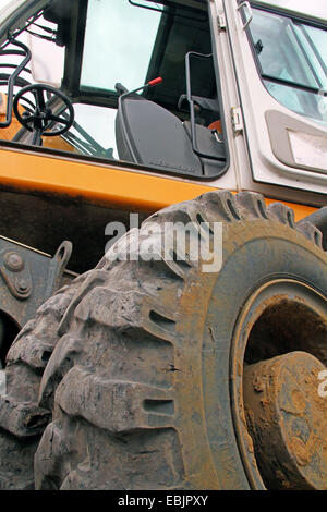 view up into the driver's cab of the wheel loader at a construction site, Germany, Nordrhein Westfalen Stock Photo