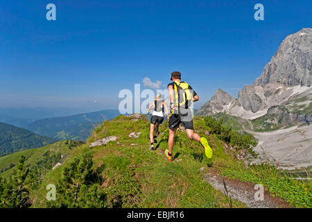 young couple trail running at the Dachstein Mountains, Austria, Styria, Dachstein Stock Photo
