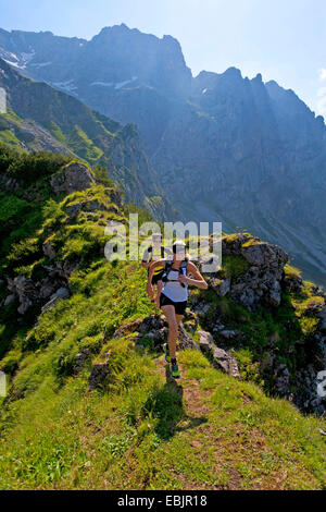 young couple trail running at the Dachstein Mountains, Austria, Styria, Dachstein Stock Photo