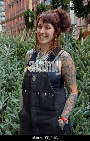Portrait of a Scottish woman with tattoos selling Christmas trees on Astor Placein Greenwich Village, Manhattan, New York City Stock Photo