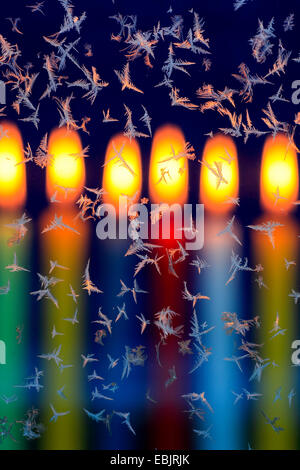frost flowers on window in candle light Stock Photo