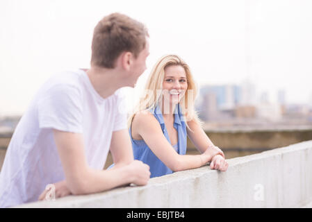 Couple leaning on wall Stock Photo