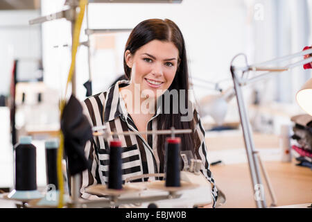 Portrait of young female seamstress in workshop Stock Photo