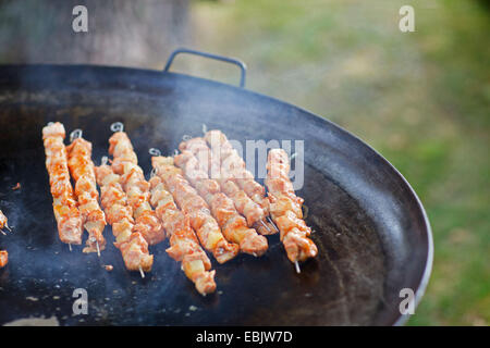 delicious skewers grilling on pan Stock Photo